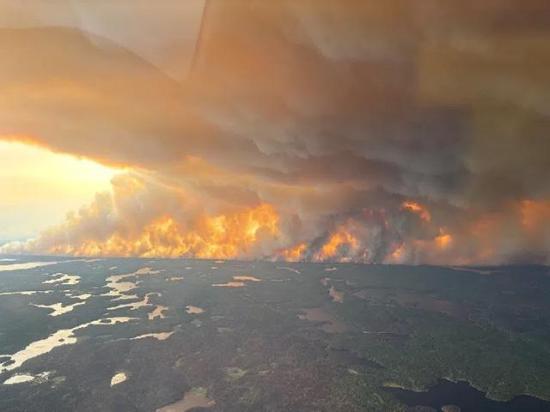 Flames and thick smoke from a wildfire near Flin Flon, Manitoba, Tuesday, May 27, 2025, exemplify this spring&#039;s harsh Canadian fire outbreak. (The Canadian Press/HO-Manitoba Government photo)