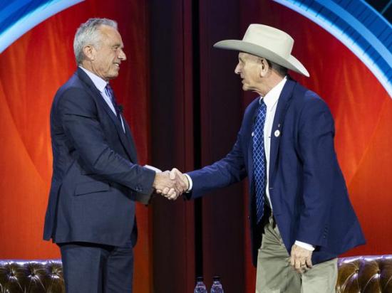 Secretary of Health and Human Services Robert F. Kennedy Jr. (left) shakes hands with National Cattlemen's Beef Association President Buck Wehrbein after the two chatted on the stage about the new dietary guidelines at CattleCon in Nashville, Tennessee. (Photo courtesy of NCBA)