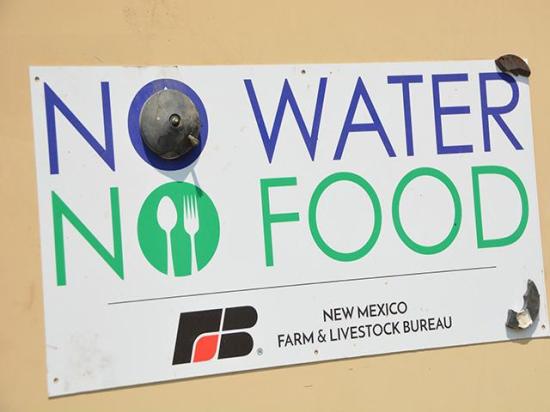 A sign on a New Mexico farm reflects some of the challenges facing farmers over irrigation in the Colorado River Basin. Federal officials announced Arizona would take a 21% cut in its water allocations, which is expected to affect farmers the most. (DTN photo by Chris Clayton)