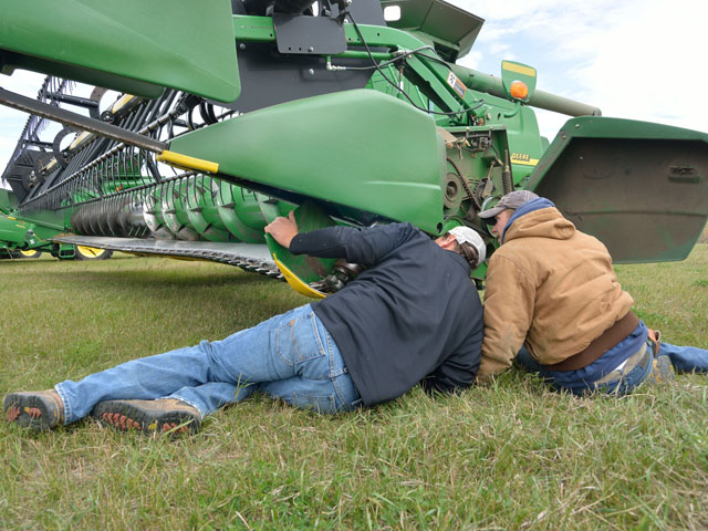 A broken header part was one more misstep in a day of trials for the Zenker family of Gackle, N.D. Here Chris Zenker and employee Taylor 