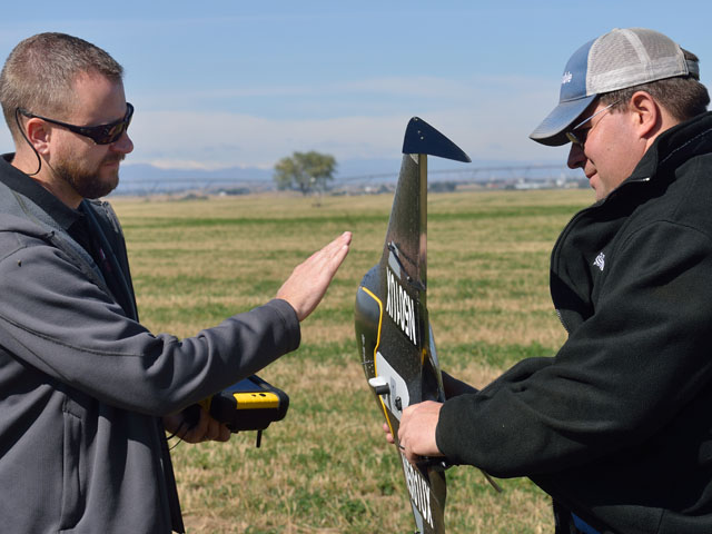 Without a licensed pilot such as Jason Downing (left), Trimble's training specialist Wade Stewart could not fly the company's UX5, an unmanned aerial system. (DTN/The Progressive Farmer photo by Jim Patrico)