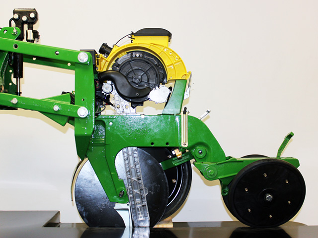 Precision Planting&#039;s SpeedTube high-speed planting system, pictured above mounted on a Deere planting unit, is at the center of a Department of Justice lawsuit to stop John Deere from purchasing Precision Planting. Deere has offered to license the technology out should the deal go through. (Photo courtesy of Precision Planting)