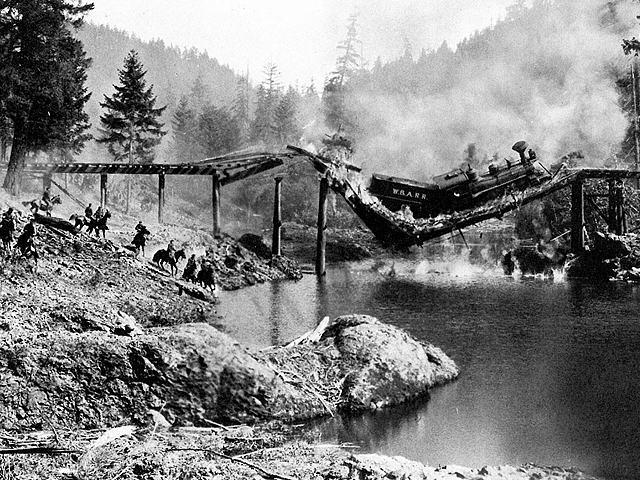 The longer the great locomotive of trade remains stopped in the middle of a critical bridge, the greater the chance of a catastrophe. (Train wreck scene from the 1926 Buster Keaton movie "The General." Photo courtesy of the Dorena Historical Society)