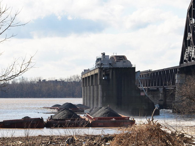 Barges are stacked up against the McAlpine Dam on the Ohio River after an accident occurred on Dec. 25. Seven of those barges eventually sunk. (USACE photo by Katie Newton)