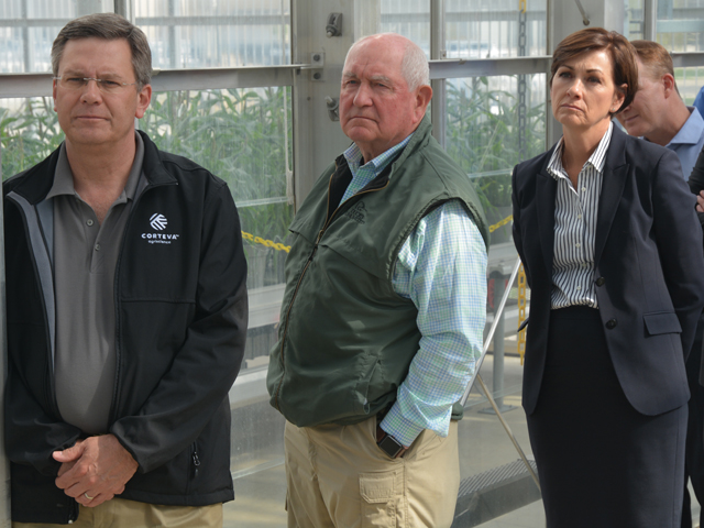 (From left to right) Jim Collins, CEO-elect of Corteva Agriscience, U.S. Secretary of Agriculture Sonny Perdue and Iowa Gov. Kim Reynolds listen as Corteva researchers talk about seed technology Monday at the Mendel Greenhouse Complex in Johnston, Iowa. (DTN/Progressive Farmer photo by Matt Wilde)
