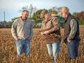Brent Lassiter, left,  from Newport, Ak., consults on all crops across Arkansas including cotton, rice, corn and soybeans. Brent used to farm about 3,000 acres in Arkansas but now runs his own consulting company. He works with Virgil "Dooby" Moore, right, his Innovation Specialist. Brent and Dooby, look over a field with farmer/client Greg King, Image by Lisa Buser