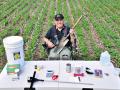 Iowa NRCS soil scientist Rick Bednarek uses a whole bucketful of tools to measure soil health but says a spade is his favorite, Image by Lynn Betts