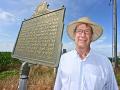 John Young stands with a marker highlighting his family-farmâ€™s distinction of being an early no-till adopter, Image image by Charles Johnson 