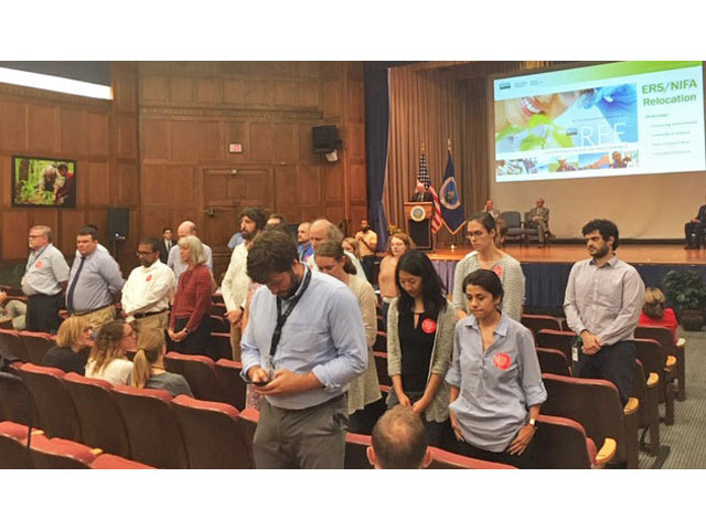 Unionized employees at ERS and NIFA turn their backs on Agriculture Secretary Sonny Perdue as he talks about moving the agencies to Kansas City, Mo. 