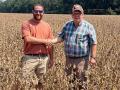 Alex Harrell, left, a soybean grower from Leesburg, Georgia, shakes hands with University of Georgia Extension Agent Doug Collins who oversaw the harvest of a 2.5-acre plot of soybeans that yielded 206.7997 bpa on Aug. 23, setting a new world record. (Photo courtesy of Alex Harrell)