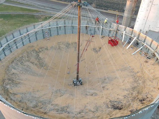 Employees of Global Bin Builders of Sioux Falls, South Dakota, replace a roof on a 330,000-bushel grain bin last fall at Key Cooperative in Nevada, Iowa. The old roof was damaged during last year&#039;s derecho that tore through the Midwest. (Photo courtesy of Stephanie Voxland)