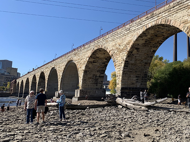 Beginning Oct. 3, the USACE St. Paul District lowered the water at the St. Anthony Falls Locks in order to inspect the Upper and Lower Locks, and in doing so, exposed the river bottom on both sides of the Mississippi River in downtown Minneapolis, including here at the Stone Arch Bridge. (DTN photo by Mary Kennedy)