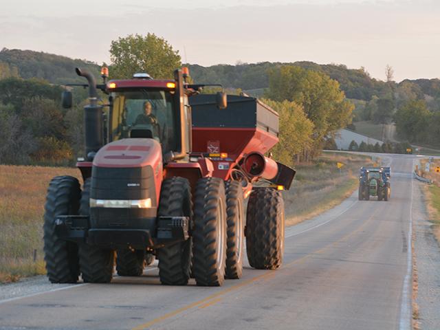 Safety features such as headlights, taillights, flashing amber lights and side-marking tape make farm machinery on public roads more noticeable to other drivers. (DTN file photo)