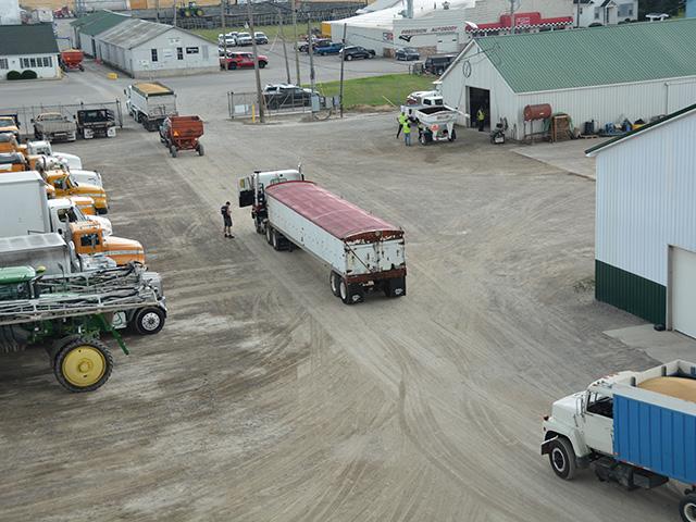 During wheat harvest, trucks and equipment line the farm headquarters. But since a March 16 Federal Motor Carrier Safety Administration rule, some workers have been unable to obtain commercial driver's licenses after the agency halted the issuance of non-domiciled CDLs in some states. (File photo by Chris Clayton)