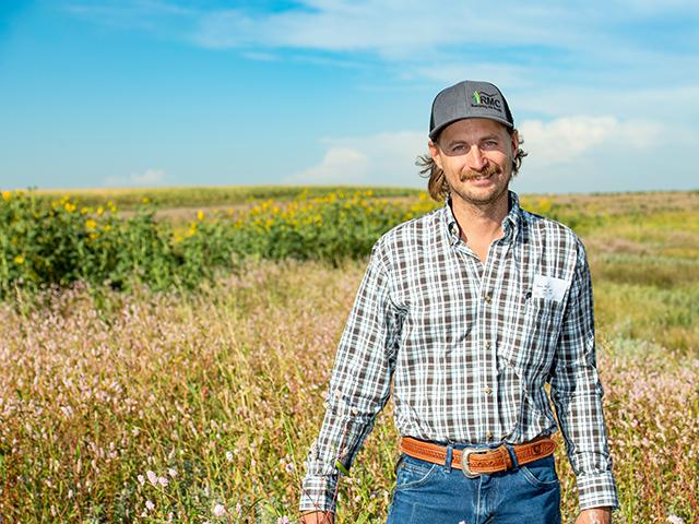 Logan Pribbeno regularly checks the native grass stands in pastures that cattle graze on their Nebraska operation. (Joel Reichenberger)