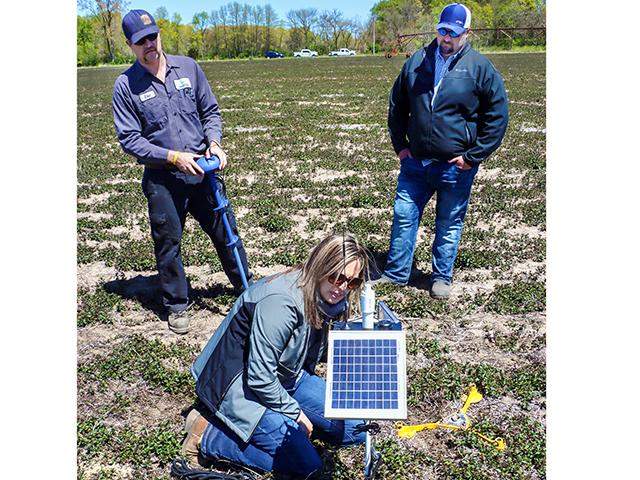 A CropX soil-probe test cut water costs by almost a third on this Indiana farm. From left, Farmer Eric Wappel, Cassie Misch and Sheldon Alt. (Dave Tonge)