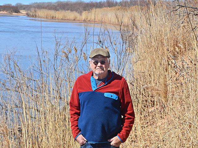 Chuck Grimes stands on solid ground where, 36 years ago, the main channel of the Cimarron River ran. Behind him, a half-mile of Shoreline common reed holds the river back during floods. (Progressive Farmer image by Dan Crummett)