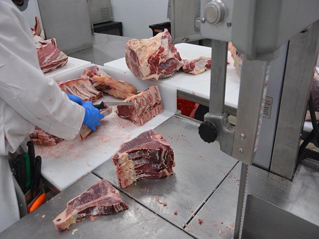 A meat cutter slices T-bone steaks at the Montana Premium Processing Co-op in Havre, Montana. The co-op was created by 60 producers with the help of the Montana Farmers Union, which would like to develop a partnership for a meat-cutting program at a local university. USDA recently provided some funding for seven schools nationally to develop more meat-cutting training programs. (DTN photo by Chris Clayton)  