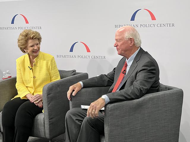 Senate Agriculture Committee Chairwoman Debbie Stabenow, D-Mich., talks with former GOP Sen. Saxby Chambliss of Georgia about the complications of writing a farm bill right now. Concerned about the efforts in the House, Stabenow said the Senate will move ahead and pass its own farm bill before December. (DTN photo by Chris Clayton) 