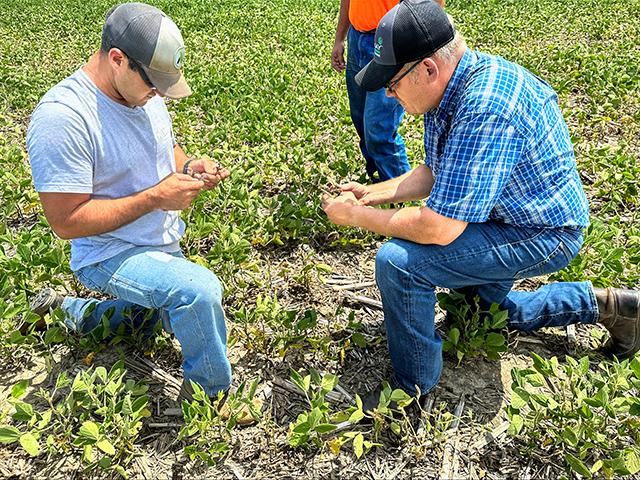 Ben Kuhn (left) with Dyna-Gro Seed agronomist Jerry Lubbehusen regularly checks fields to assess any potential problems. (Provided by Nutrien Ag Solutions Dyna-Gro Seed)