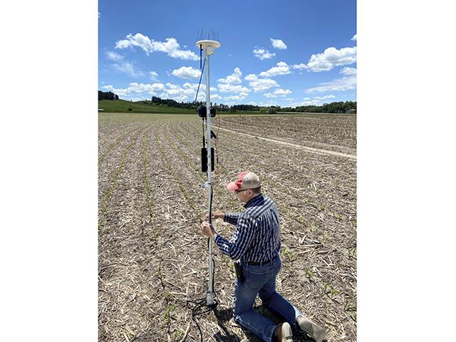 A University of Nebraska researcher sets up a sensor to measure atmospheric aridity to improve irrigation. (University of Nebraska)