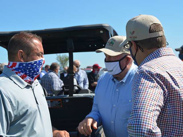 Kevin Ross, an Iowa farmer and president of the National Corn Growers Association, left, talks with Agriculture Secretary Sonny Perdue at a conservation event on a farm near Radcliffe, Iowa, on Thursday. Perdue declared an agricultural disaster for 18 counties hit hard by a windstorm in mid-August. (DTN photo by Chris Clayton) 