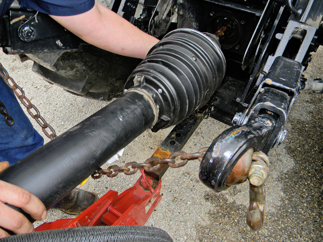 If your tractor is equipped with a three-point hitch, one way to help avoid finger injury from a CV joint that hooks to the PTO is to tie a small chain through the balls in the drag/lift links on the tractor. (DTN image by Steve Thompson)