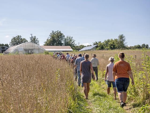 A group of field days attendees in August of 2022 visit Yellow Table Farm in Tripoli, Iowa, and explore how Eric and Courtney Jensen were working to create a silvopasture system on former row crop ground. (Photo courtesy of Practical Farmers of Iowa)