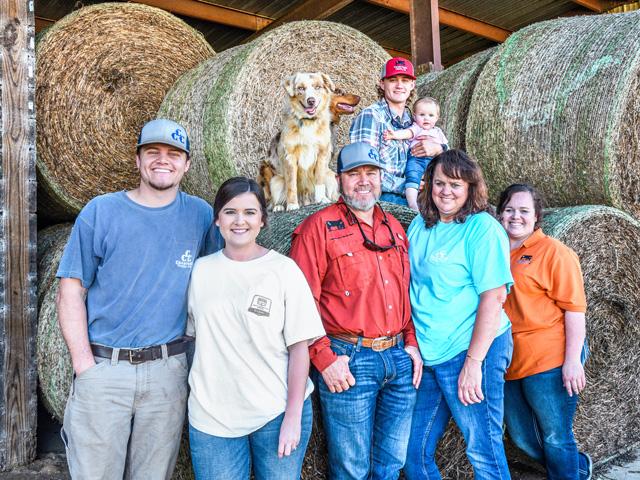 At Georgia&#039;s Crawford Cattle Co., alternative feeds, including things like hominy and whole cottonseed, help manage costs. (Bottom row from left to right) Tanner Crawford, Kylie Keene, Phillip Crawford, Melissa Crawford, Erica Hasty and (top row) Chandler Crawford with Paisley Hasty. (DTN/Progressive Farmer file photo by Becky Mills)