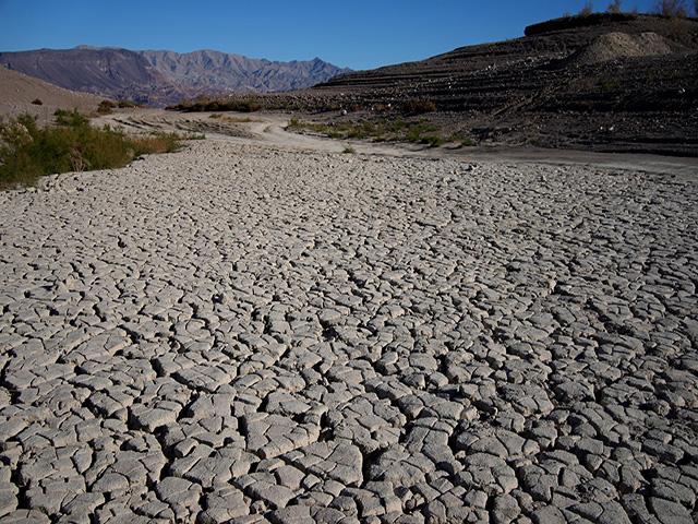 Cracked earth in an area once under the water of Lake Mead, the largest man-made reservoir in the U.S., at the Lake Mead National Recreation Area, Friday, Jan. 27, 2023, near Boulder City, Nev. Hoover Dam provides electric power, drinking water and irrigation mainly in Nevada and California. Credit: AP Photo/John Locher 2023