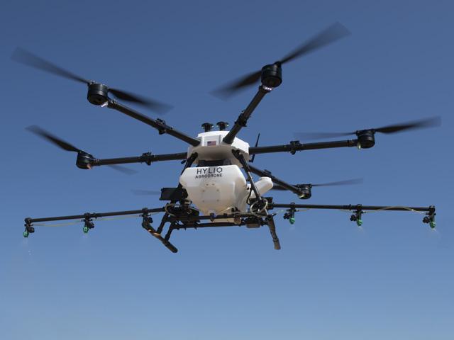 An older Hylio drone flies in 2021. Hylio is one of several companies building aerial spraying drones that could be large and capable enough to spark change in the industry. (DTN/Progressive Farmer photo by Joel Reichenberger)