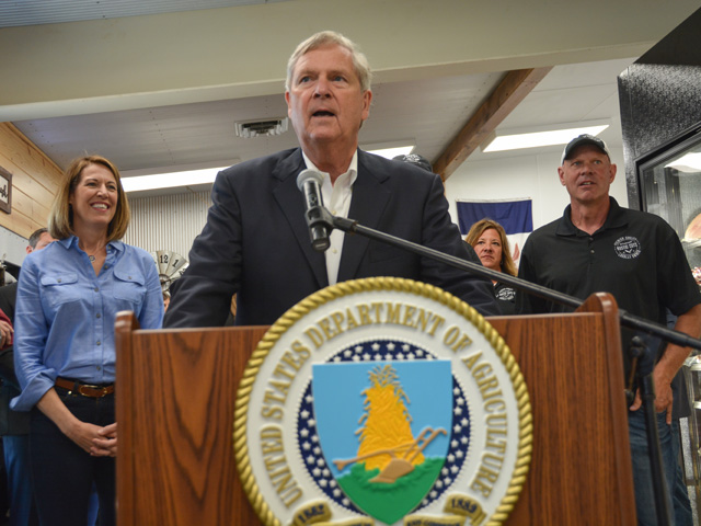 U.S. Agriculture Secretary Tom Vilsack speaks Friday about competition issues and $500 million to expand meat and poultry processing at a small meat locker, Rustic Cuts, in Council Bluffs, Iowa. With Vilsack were Rep. Cindy Axne, D-Iowa, (left) and Rick Larson, co-owner of Rustic Cuts (right). (DTN photo by Chris Clayton)