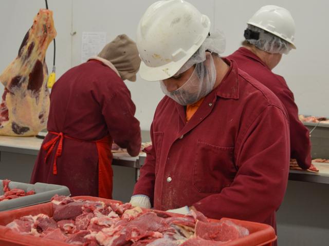 Meat cutters at a beef processing plant. Meat processors and retailers marketing products with claims such as raised without antibiotics could be required to provide more proof of those claims for USDA to allow them to be used. The Food Inspection Service Agency announced it is taking steps to tighten those guidelines. (DTN file photo) 