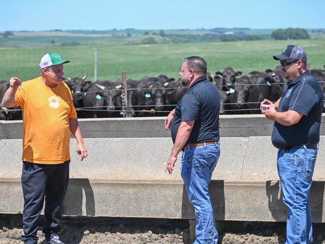 Brad Feddersen, left, co-owner of Feddersen USA Wagyu near Anthon, Iowa, shows John Turner, center, and Alex Brain one of the operation&#039;s feedyards and how cattle are raised. Turner and Brain work for Fareway, which has agreed to buy most of Feddersen&#039;s cattle and sell the meat in its grocery stores and online. (DTN photo by Matthew Wilde)