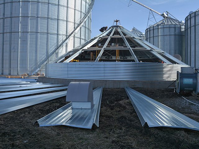 Employees of C&amp;S Construction Grain Bin Services of Higginsville, Missouri, build a grain bin on the Stalzer family farm near Haverhill, Iowa. The bin replaces one destroyed in last year&#039;s derecho that struck the Midwest. (DTN photo by Matthew Wilde)