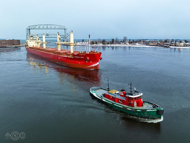 The Fednav Limited Federal Dart enters the Duluth harbor assisted by a tug, on its way to drop of its load of 23,000 short tons of Turkish cement destined for the CRH/Ash Grove Cement Company terminal on Rice&#039;s Point in Duluth, Minnesota. (Photo courtesy of Schauer Photo Images)