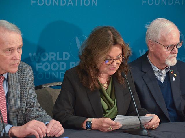 Heidi Kuhn, the 2023 World Food Prize laureate, reads a statement from herself and other laureates calling on governments around the world to increase aid for food assistance and agricultural development because of rising global conflicts. David Beckmann (left) is a 2016 laureate and founder of Bread for the World. Per Pinstrup-Andersen (right) is a 2001 laureate, Danish economist and retired professor. (DTN photo by Chris Clayton)