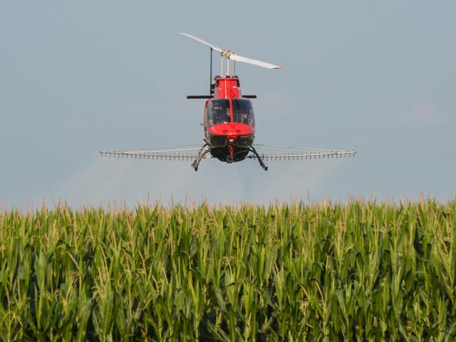 Fungicide is applied to corn in August 2021 near Monona, Iowa. Tar spot, a foliar disease, is spreading across the Corn Belt. (DTN photo by Matthew Wilde)