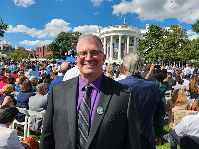 Aaron Lehman, president of the Iowa Farmers Union, at the White House in September during a celebration of the Inflation Reduction Act. During the Iowa Caucuses, Lehman interviewed several presidential candidates who made the effort to attend the Iowa Farmers Union convention. Midwest farmers may lose that opportunity with a shift in the Democratic presidential primary calendar. (Photo courtesy of Iowa Farmers Union) 