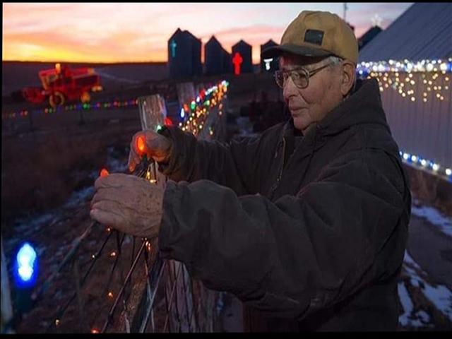 Jack Baird installing lights on his Christmas display at his farm near Red Oak, Iowa. His light display in rural southwest Iowa would draw more than a thousand vehicles from the area each year. Baird, who had just turned 91, passed away on Christmas day. (Photo from Baird&#039;s Christmas Lights Facebook page)