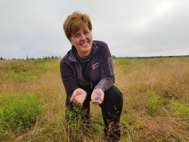 Canadian Agriculture Minister Marie-Claude Bibeau at a blueberry farm in Nova Scotia in 2019. Bibeau defends the Canadian government's goals to reduce fertilizer emissions 30% as an ambitious goal but said there are incentives and technology to make it work. (Image from Agriculture and Agri-Food Canada)  