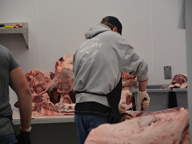 A worker at a small butcher shop in Iowa cuts meat. Agriculture Secretary Tom Vilsack on Wednesday raised concerns with large meat companies about avoiding illegal child labor in their supply chains following recent investigations. (DTN file photo by Chris Clayton)