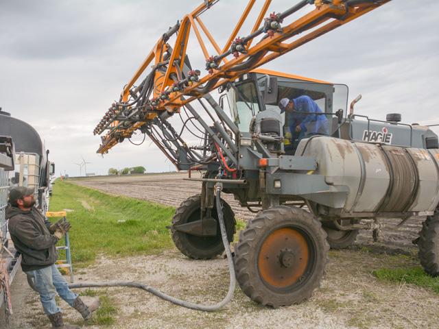 Loading up sprayer tanks with herbicides, like the Hagie sprayer above, will be expensive this spring, as pesticide shortages and high prices are expected to persist through the 2022 growing season. (DTN photo by Matt Wilde) 
