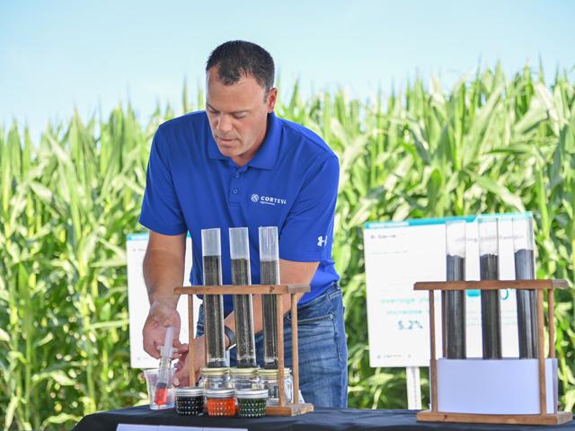 Mike Koenigs, a member of Corteva Agriscience&#039;s new Nutrient Maximizer Team, demonstrates how fast nitrogen can move through soil at the company&#039;s Summer Media Day on July 14 at the Johnston, Iowa, campus. (DTN photo by Matthew Wilde)