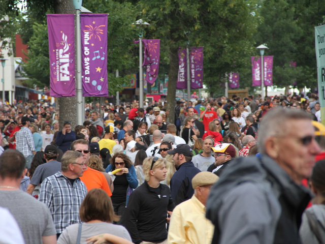 Large crowds walk through the Minnesota State Fair in St. Paul. The 2020 state fairs in at least 15 states, including Minnesota, have been canceled due to the COVID-19 pandemic. (DTN photo by Elaine Shein)