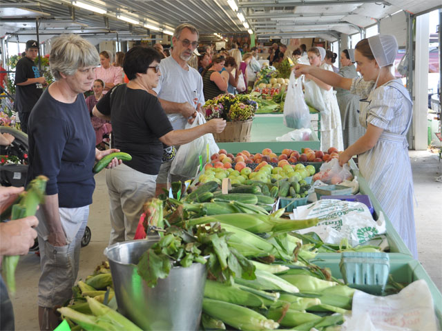 Farmers markets throughout the spring and summer can often be crowded social gatherings, though close to 160,000 farmers rely on sales at nearly 9,000 farmers markets nationally. While some farmers markets have been allowed to remain open so far this spring, challenges combatting COVID-19 could limit both vendors and customers. The Windmill Farm and Craft Market operates in the Finger Lakes region of New York State. (DTN file photo by Chris Clayton)