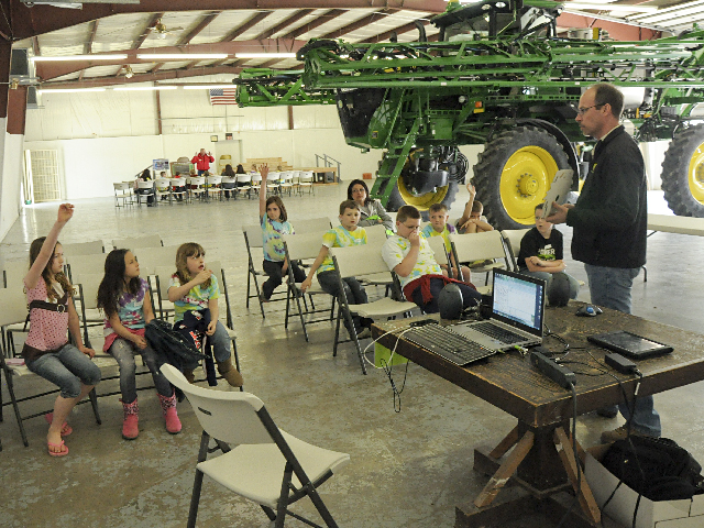 Third graders from Arlington Elementary learn about agricultural technology from Kelly Johnson with Platte Valley Equipment at the Ag Literacy Festival held at the Washington County Fairgrounds in Arlington, Neb., on May 2. (DTN photo by Russ Quinn)