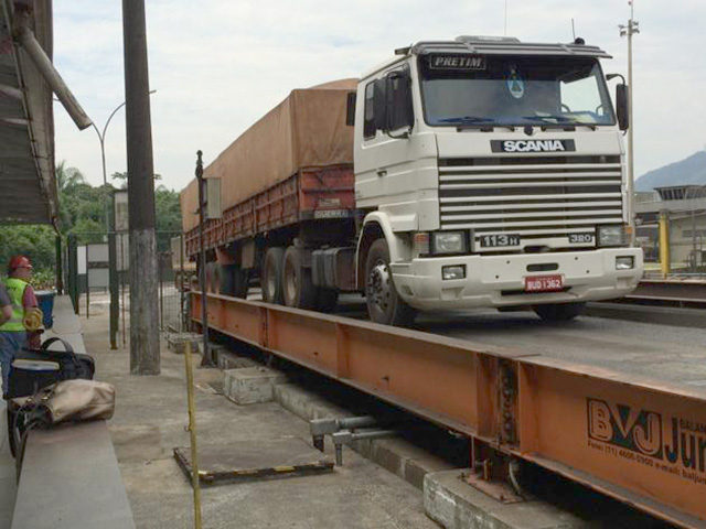 A truck crosses a weigh scale near a port in Brazil. Farmers are used to trucker strikes, but now their commodity prices may be under more pressure than just because of the current strike that stretched into its eighth day on Monday. The U.S. and China have started easing some of their trade pressures. (DTN file photo)