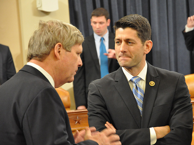 House Speaker Paul Ryan talks with former Agriculture Secretary Tom Vilsack during a hearing in 2015 when Ryan chaired the Ways & Means Committee. 
