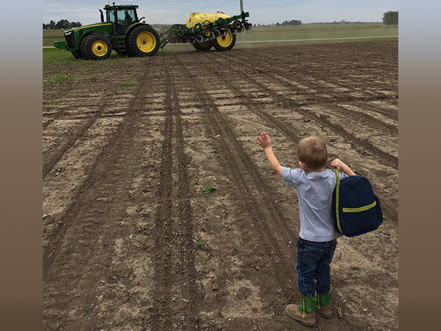 William Pistorius flags down his father, Pete, to take a healthy and therapeutic lunch break during spring planting near Blue Mound, Illinois. (Photo Courtesy of Pistorius Farms) 